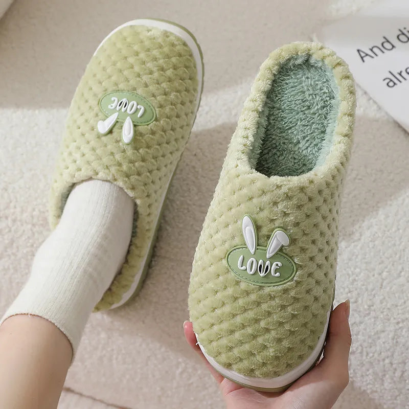 Women's rabbit plaid design winter slippers with artificial fur upper and thick rubber sole.
