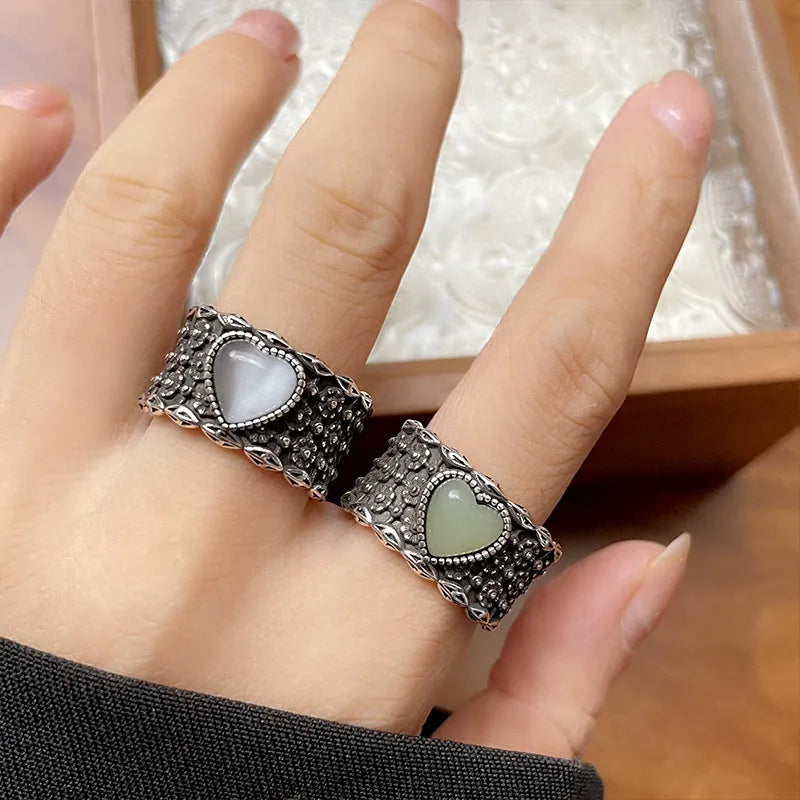 Retro-style adjustable silver heart ring shown in white and green colour options.