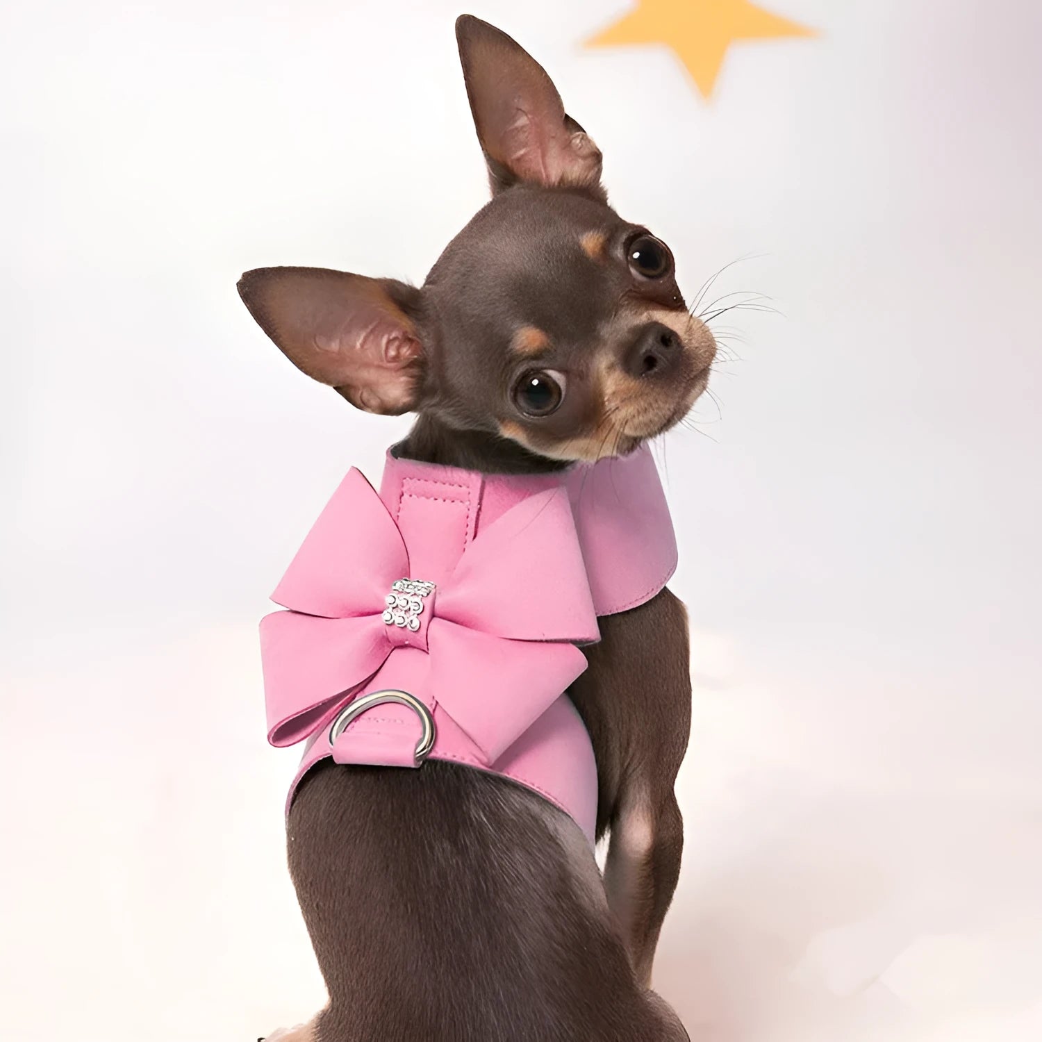 A pink microfiber dog harness with a decorative bowknot on the collar, sized for a small puppy.
