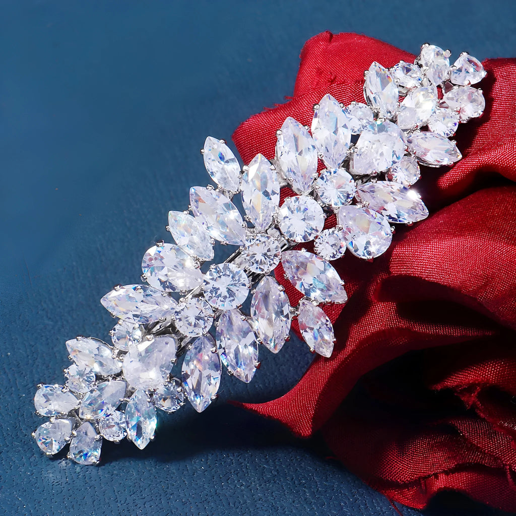 Women's inlaid zircon spring clip barrettes with electroplated leaf design on a neutral background