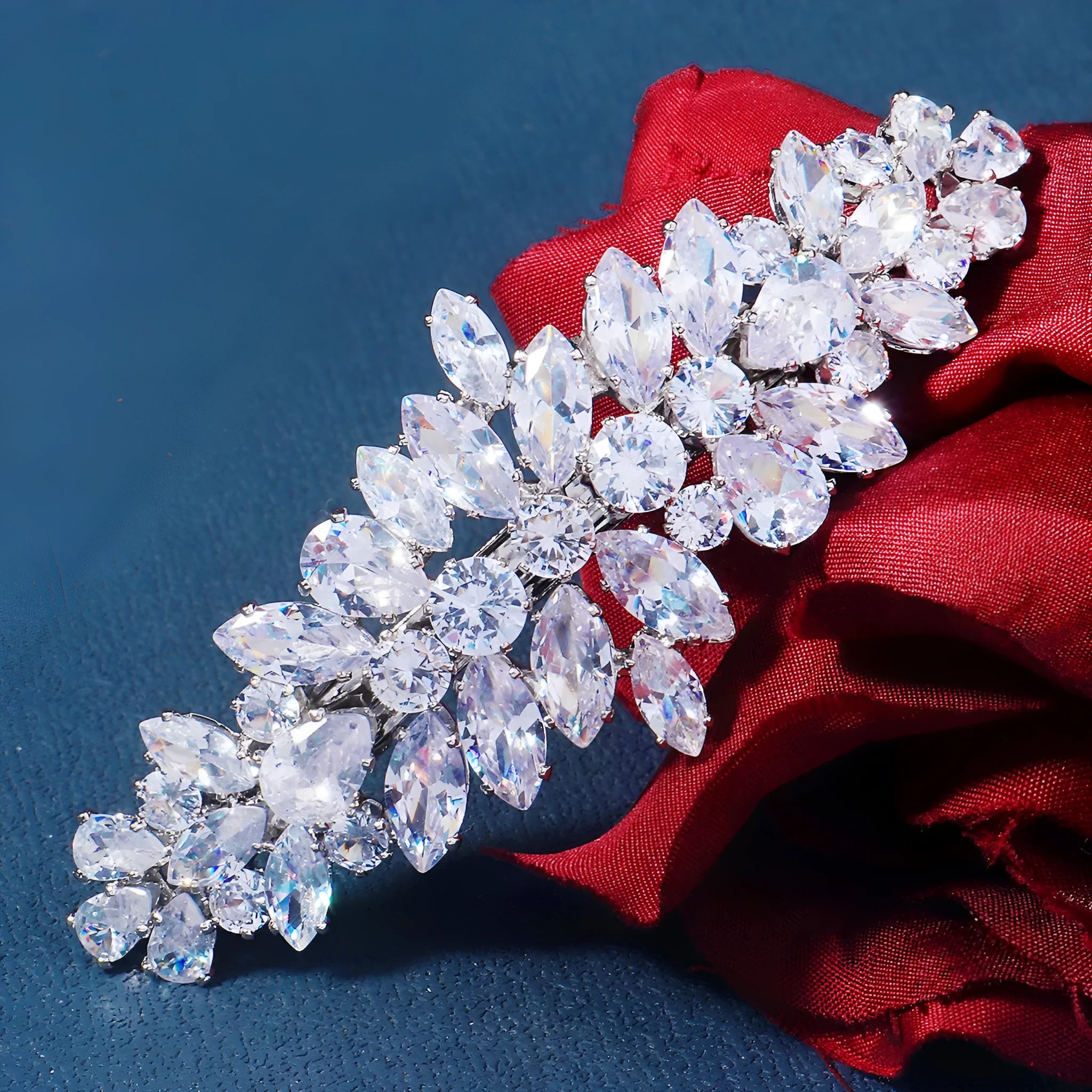Women's inlaid zircon spring clip barrettes with electroplated leaf design on a neutral background