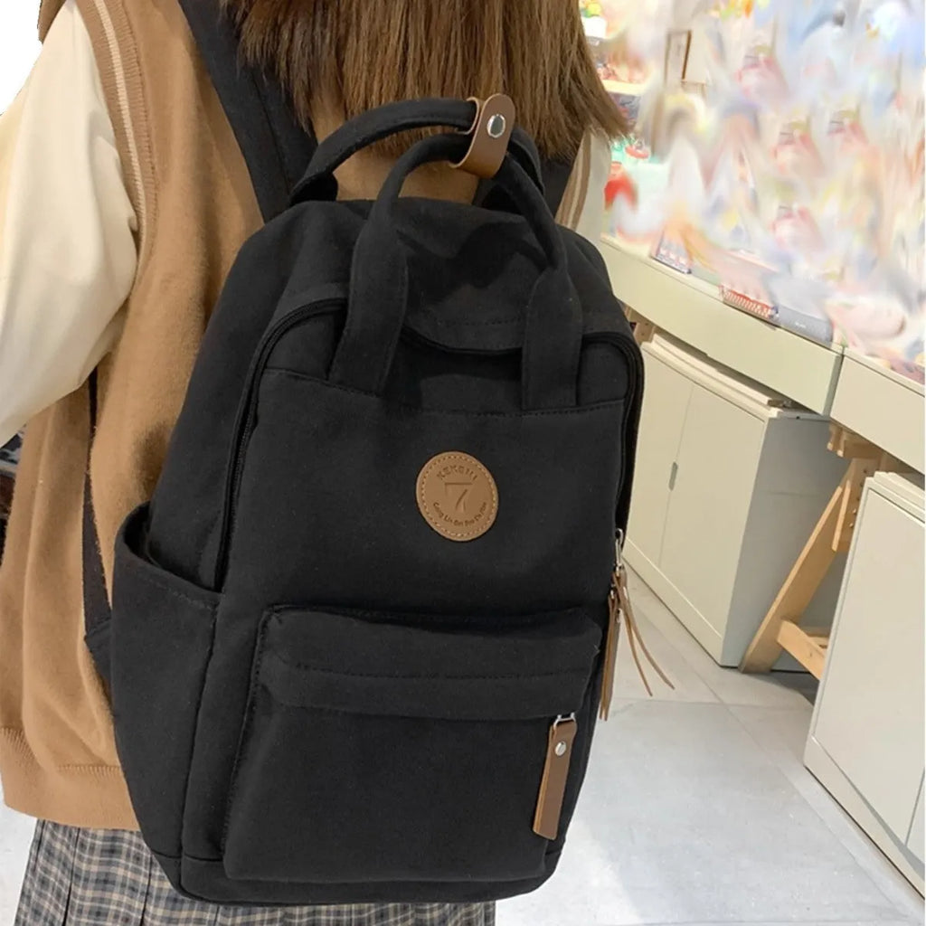 Black Oxford cloth fashion backpack with retro sewing thread detailing and curved shoulder straps