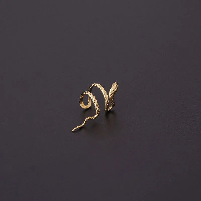 Metal snake-shaped ear clip non-piercing earring in silver finish on earlobe