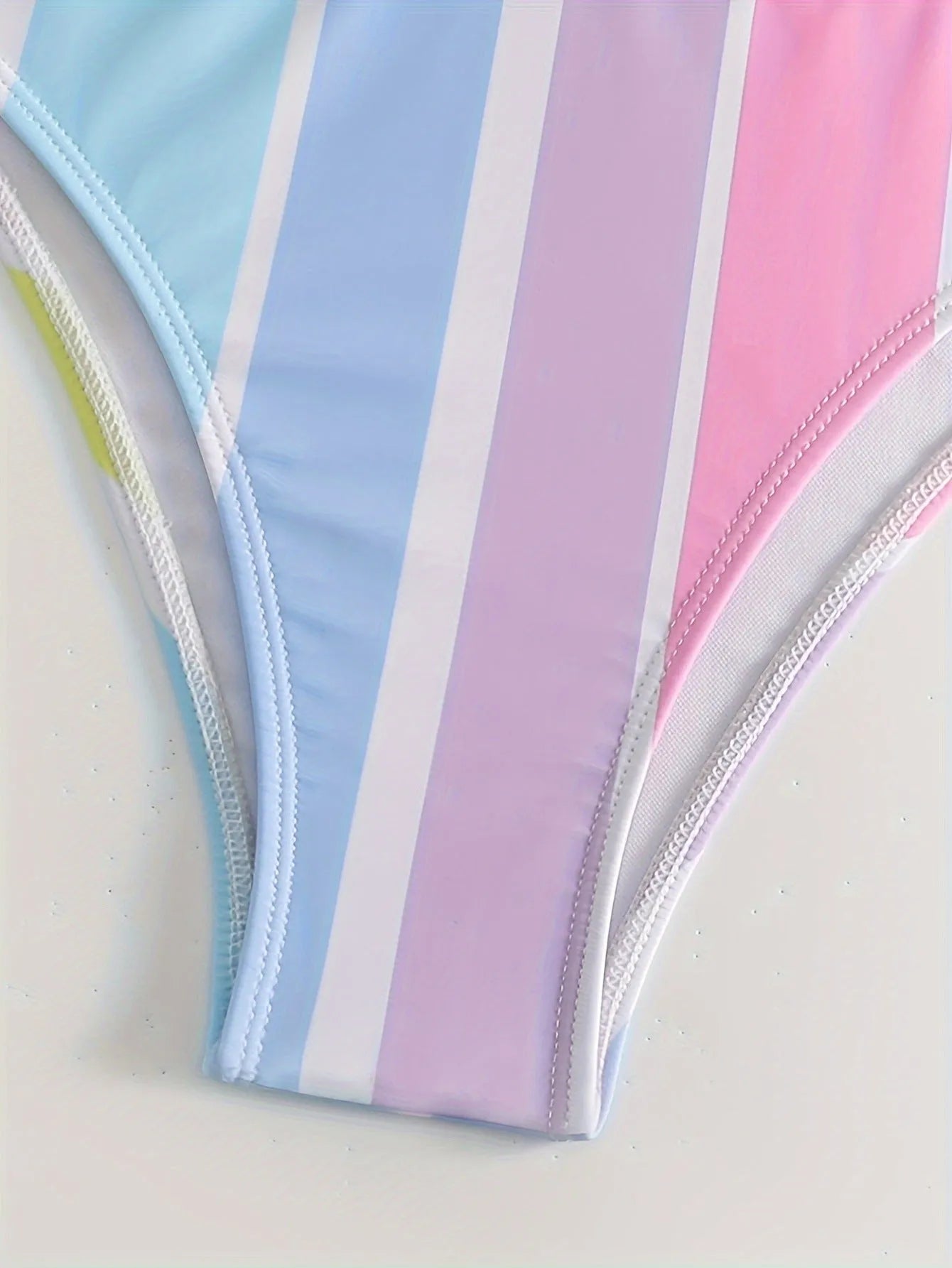 Women's striped bikini top and briefs set on a mannequin, showing the European-American style brief cut and spandex lining.