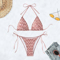 Green backless women's bikini set with halter neck strap and matching shorts.