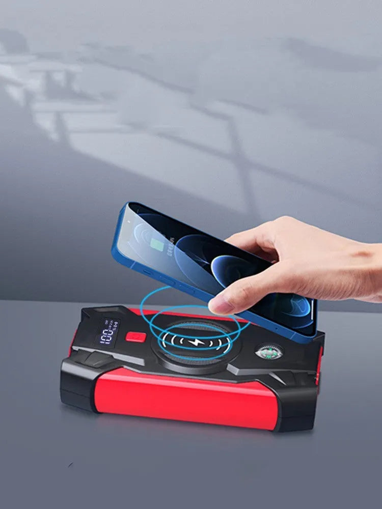 Red car emergency jump starter power pack with digital display and air pump inside a storage case.