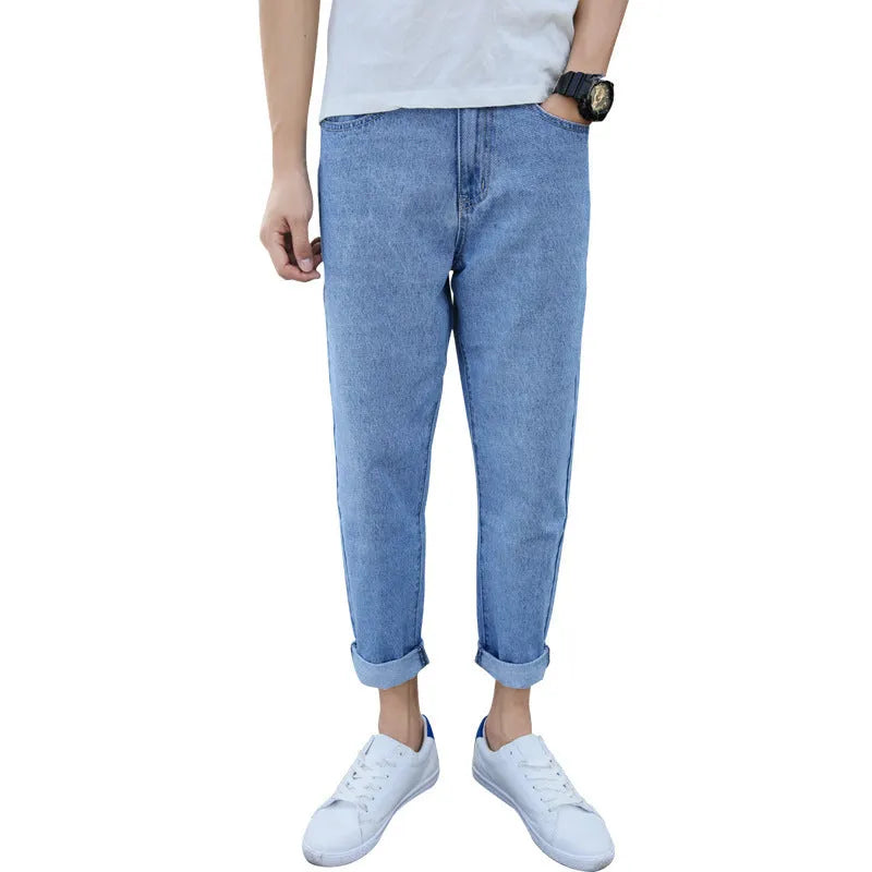 Men's black loose straight leg harem jeans on a neutral background