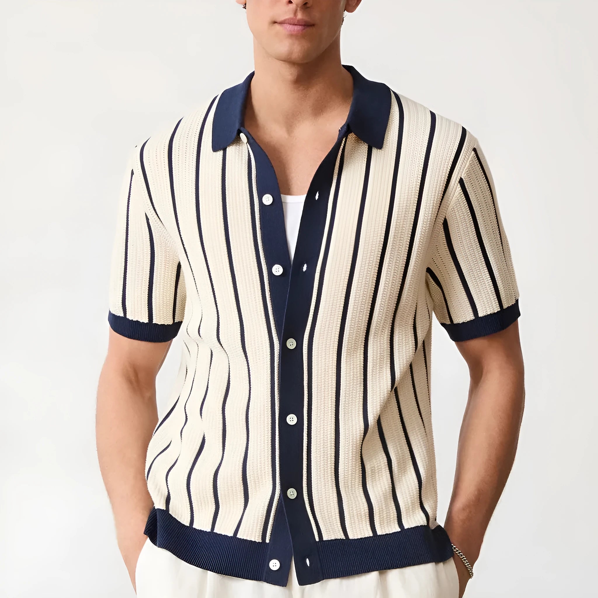 White men's lapel knitted short sleeve shirt with asymmetric stripe design on a hanger.