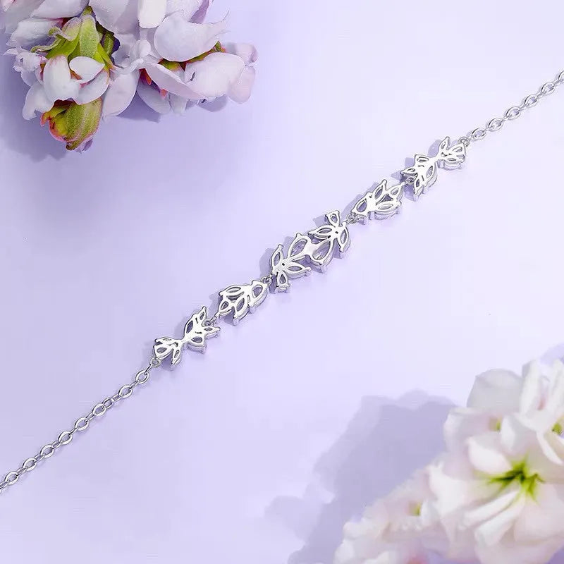 White copper wisteria flower bracelet with electroplated white gold finish featuring bow leaf and drop shapes
