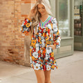 Orange floral print mini dress with lace trim, V-neck, and long sleeves on a hanger.