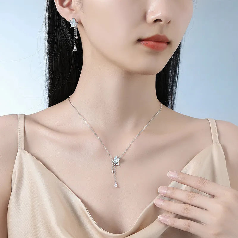 925 sterling silver butterfly tassel noctilucent necklace with O-ring chain on model, luminous pendant visible in low light