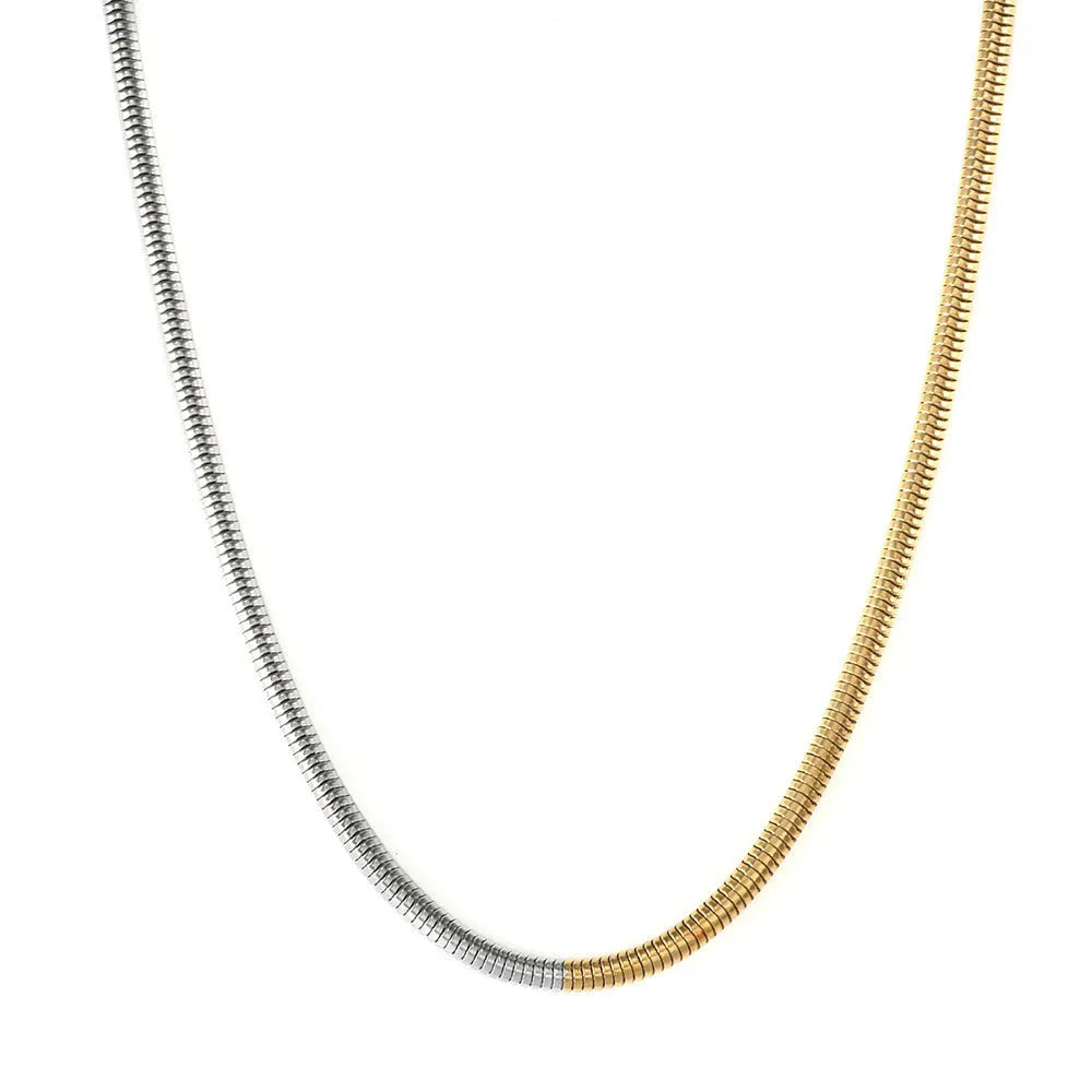 Gold tone stainless steel snake bone chain necklace with geometric line details, shown on a plain background.
