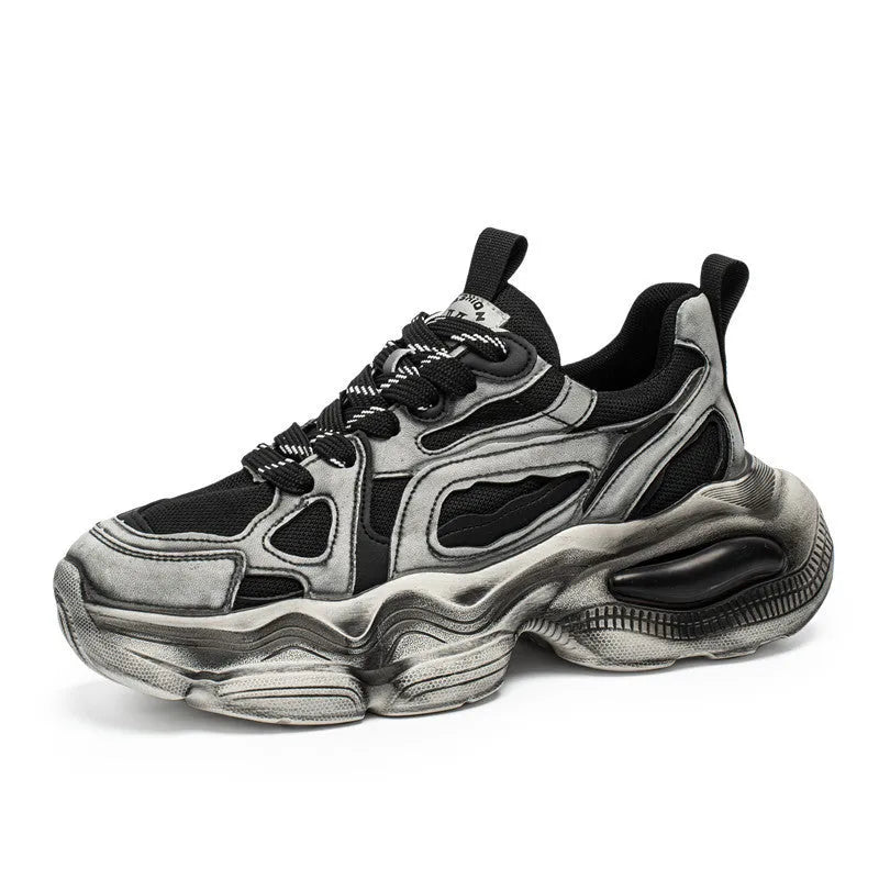 Men's black and white mesh sneakers with a platform sole and lace-up front on a plain background.
