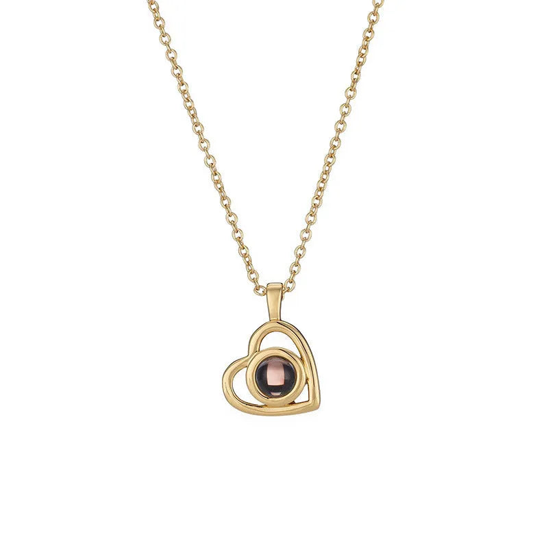 100 Languages I Love You necklace with heart-shaped charm showing custom photo projection inside, in gold finish