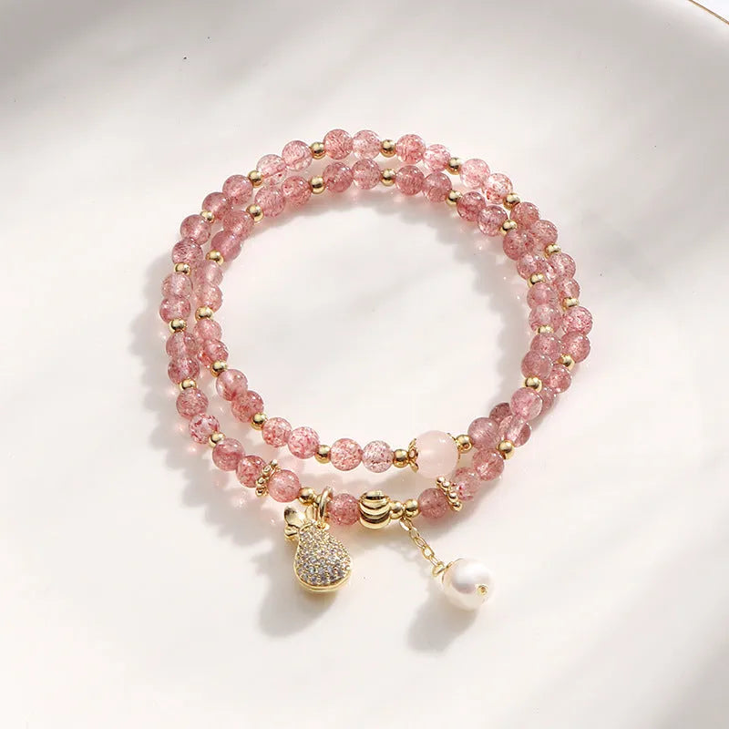 A geometric wallet bracelet for women made from pink strawberry quartz crystal.