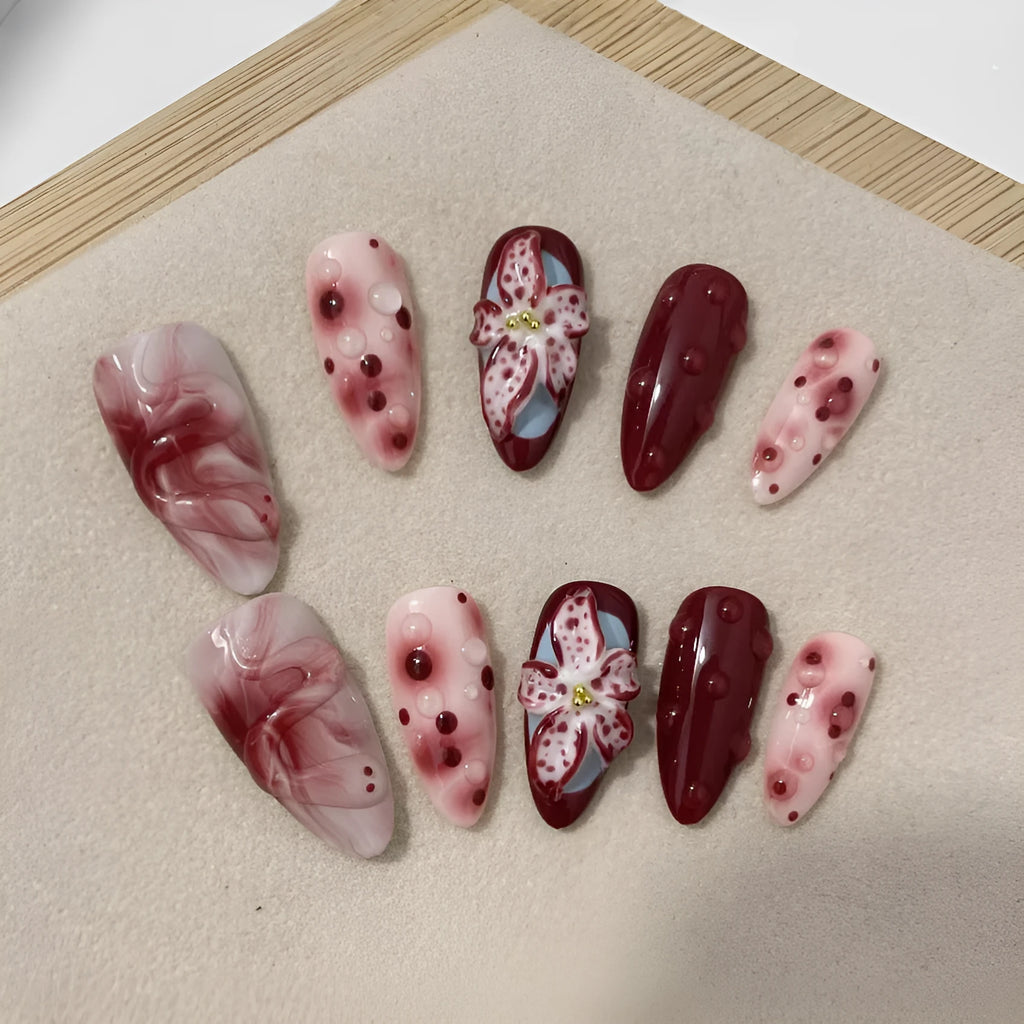 Hand-painted 3D sculpted press-on false nails with multiple patterns in almond shape