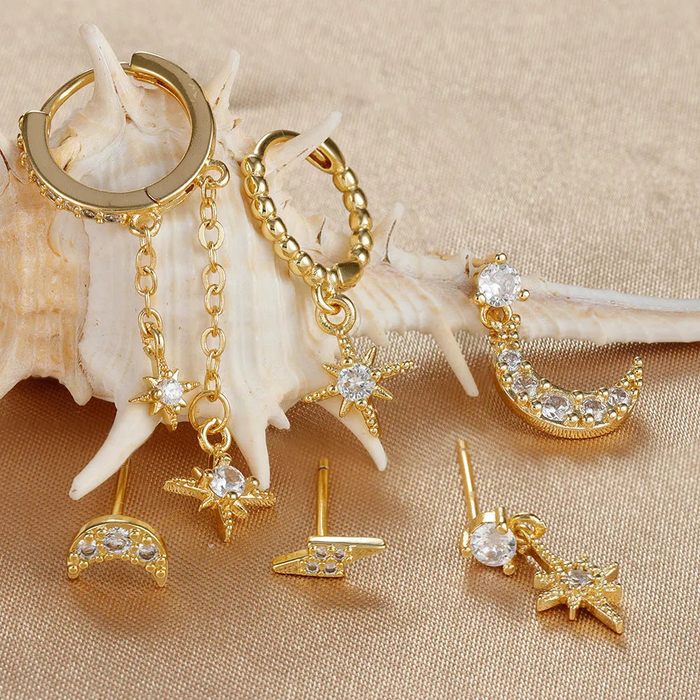 Six gold-coloured chain tassel earrings with zircon stones arranged together