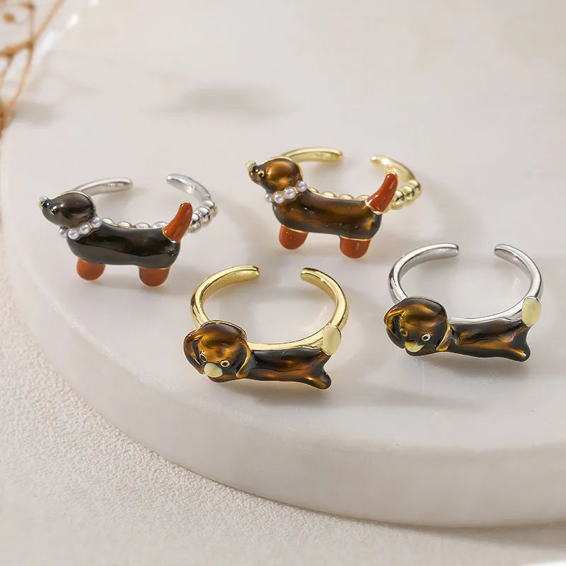 Copper open mouth ring with colourful drip oil finish and sausage dog animal motif