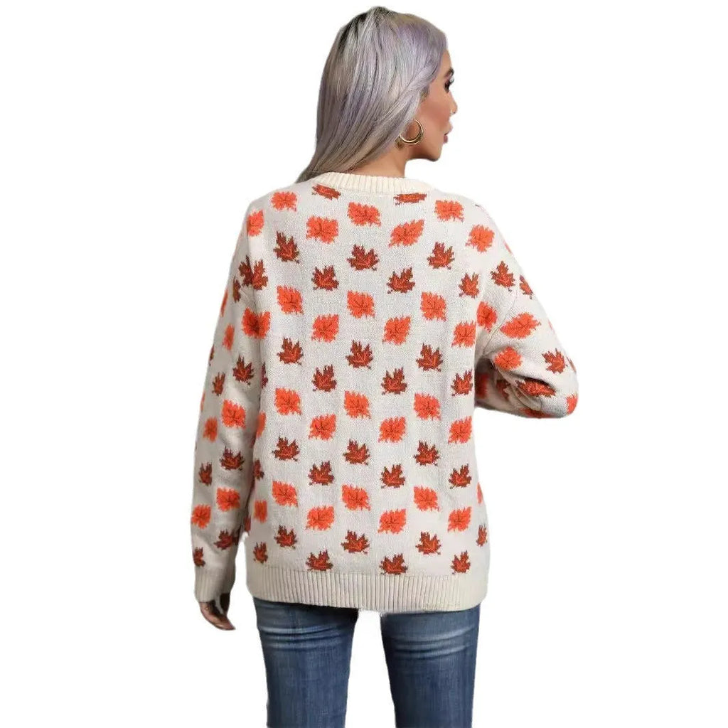 Beige and dark green loose fit Christmas sweater with maple leaf design and round neck.