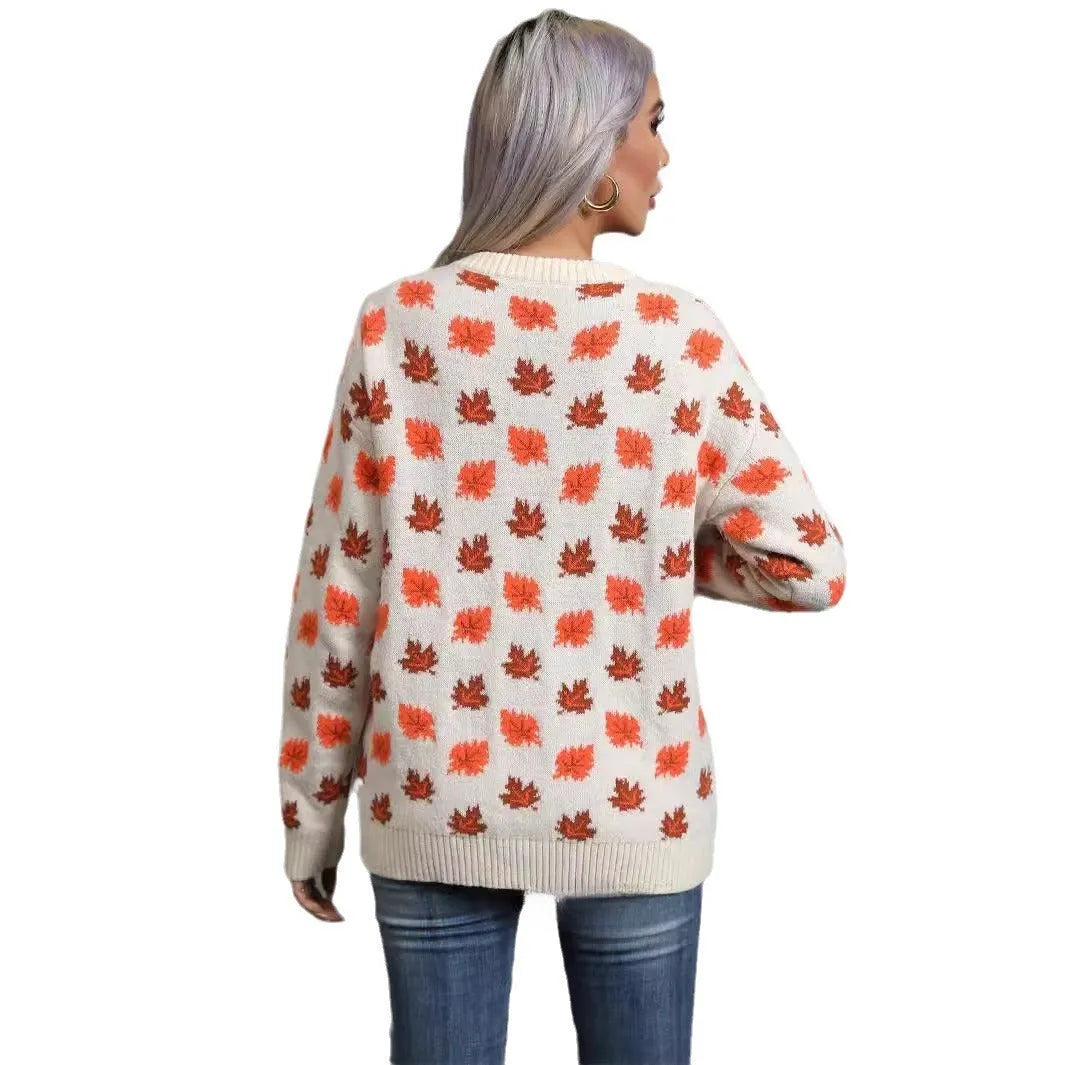 Beige and dark green loose fit Christmas sweater with maple leaf design and round neck.