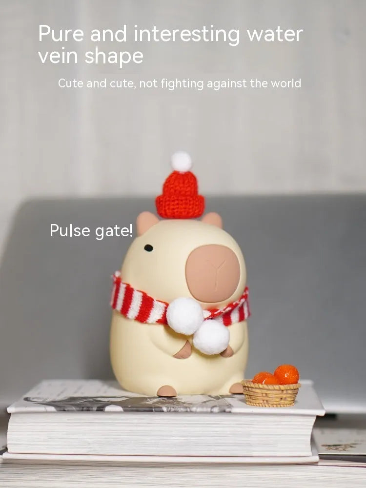 Cute brown Capybara silicone night lamp with soft glow on a bedside table.
