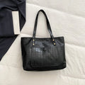 Retro large capacity single-shoulder handbag in brown, soft PU material with stitching detail, horizontal square shape.