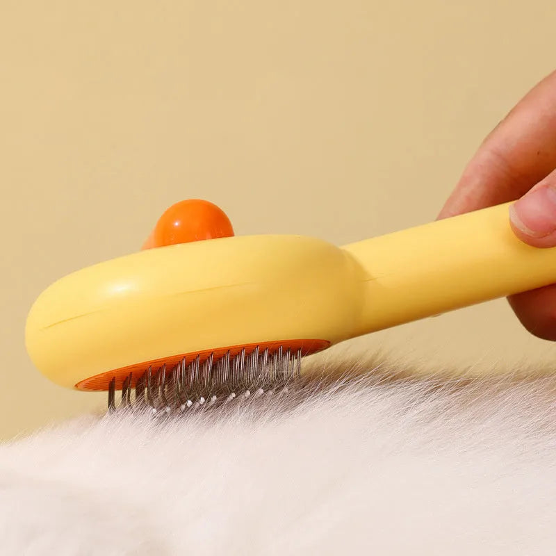 Small yellow duck comb with needle pins for pet hair removal on cats and dogs
