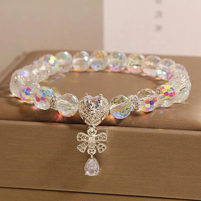 White crystal women's bracelet with butterfly and water drop charms on a metal chain, Japanese Korean style snowflake element.