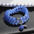 Opal cat eye bracelet with three geometric rings and lucky cat charms on adjustable 52cm cord
