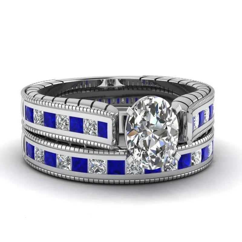 Blue alloy couple ring set with white diamond-style detail on white background