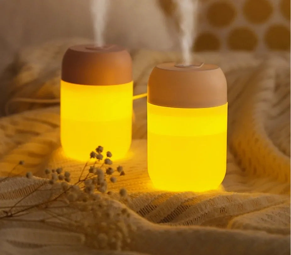 Small white cylindrical USB-powered personal humidifier on a desk.