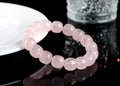 Pink crystal barrel bead bracelet on a black adjustable cord, showing geometric design.