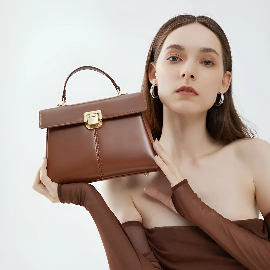 Black genuine leather women's clasp shoulder bag with square shape and long strap.