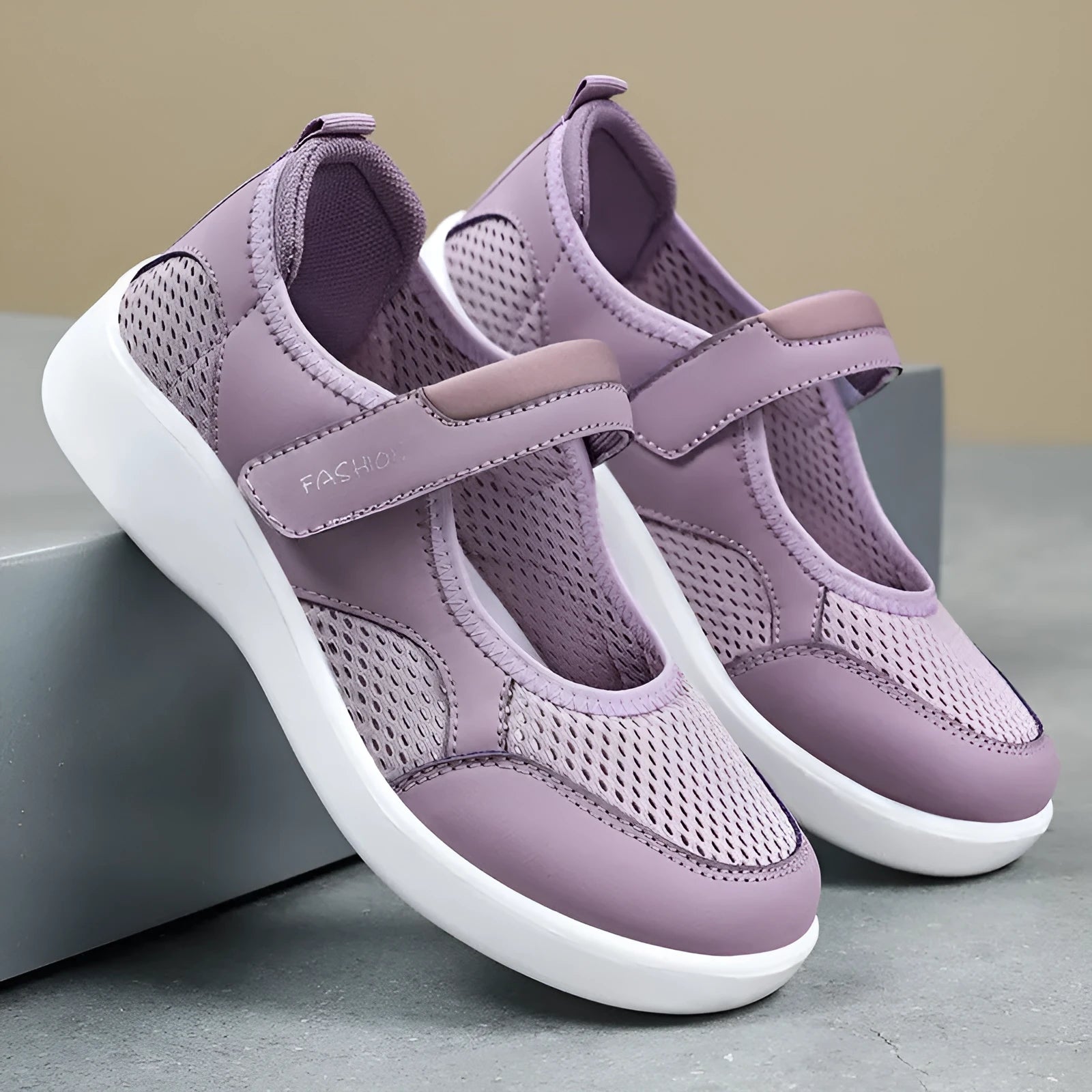 Women's low-top casual shoes in grey with mesh upper and Velcro strap.