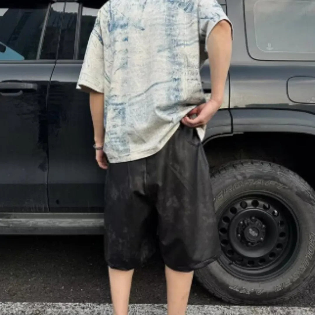 Men's loose-fit short-sleeve T-shirt with distressed print and tie-dye pattern on grey fabric.