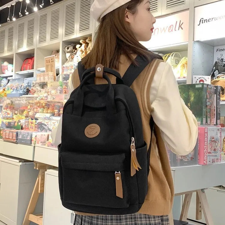 Black Oxford cloth fashion backpack with retro sewing thread detailing and curved shoulder straps