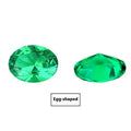 Cultivated emerald gemstone in Columbia green treasure colour on a white background.