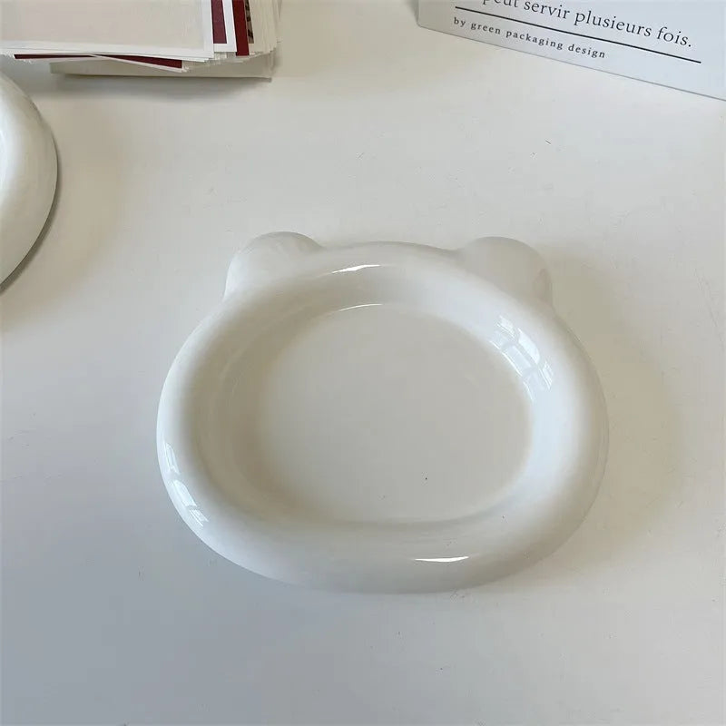 White porcelain plate with doodle design, shown in round and bear shapes, small and large sizes.