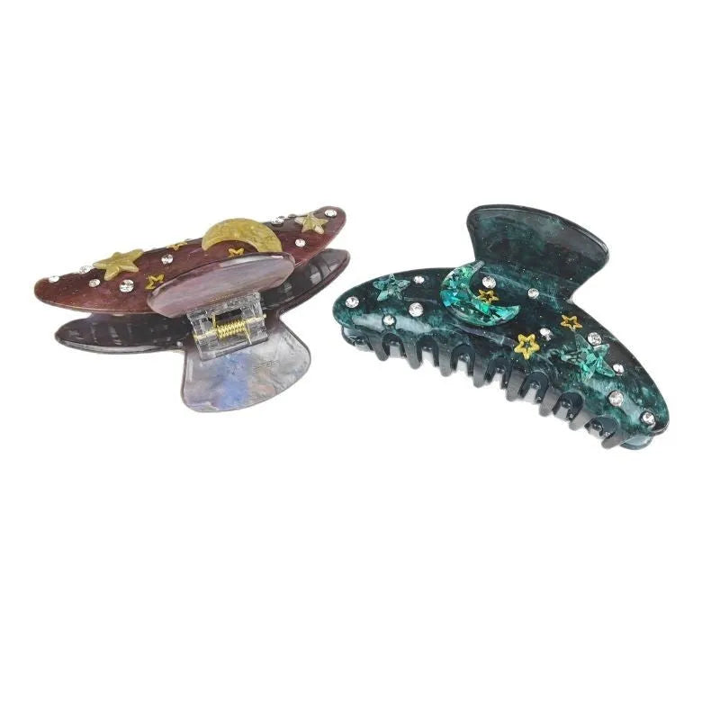 Oversized star and moon barrette in starry sky design with cellulose acetate sheet construction