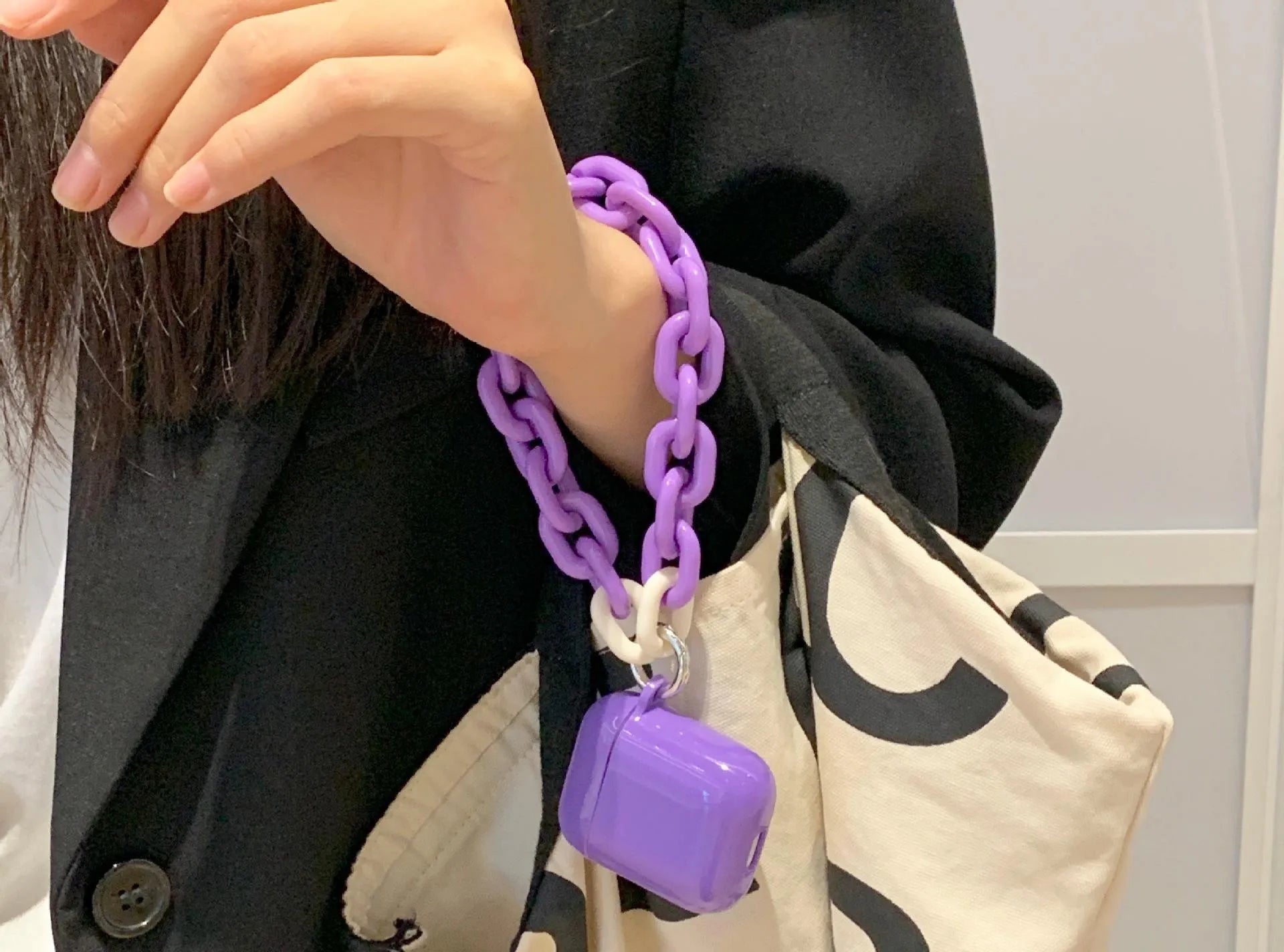 Silicone protective sleeve for AirPods case in green and purple colours with chain earphone shell design