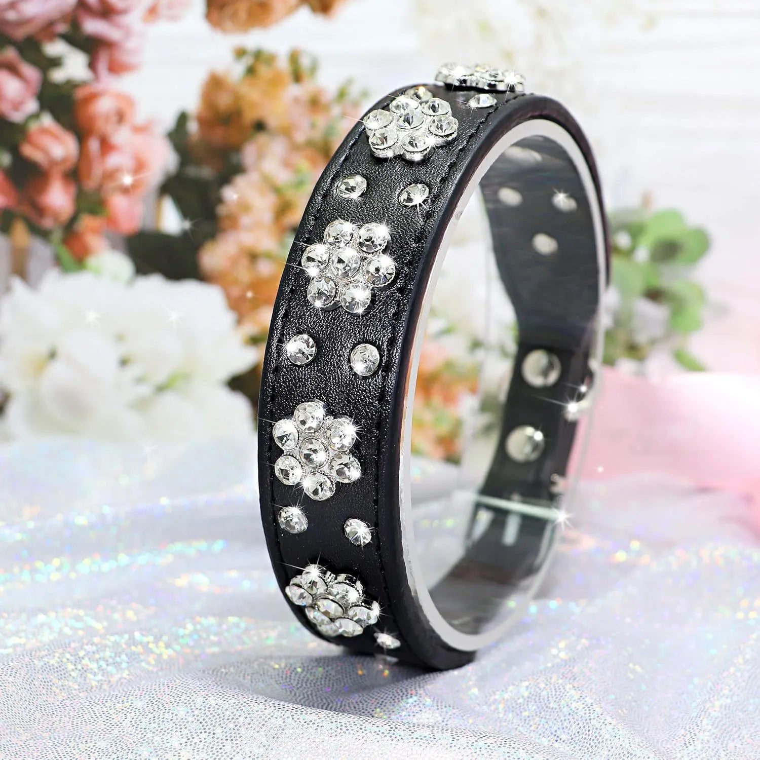Black PU leather dog collar with studded rhinestone flower pattern and metal D-ring.