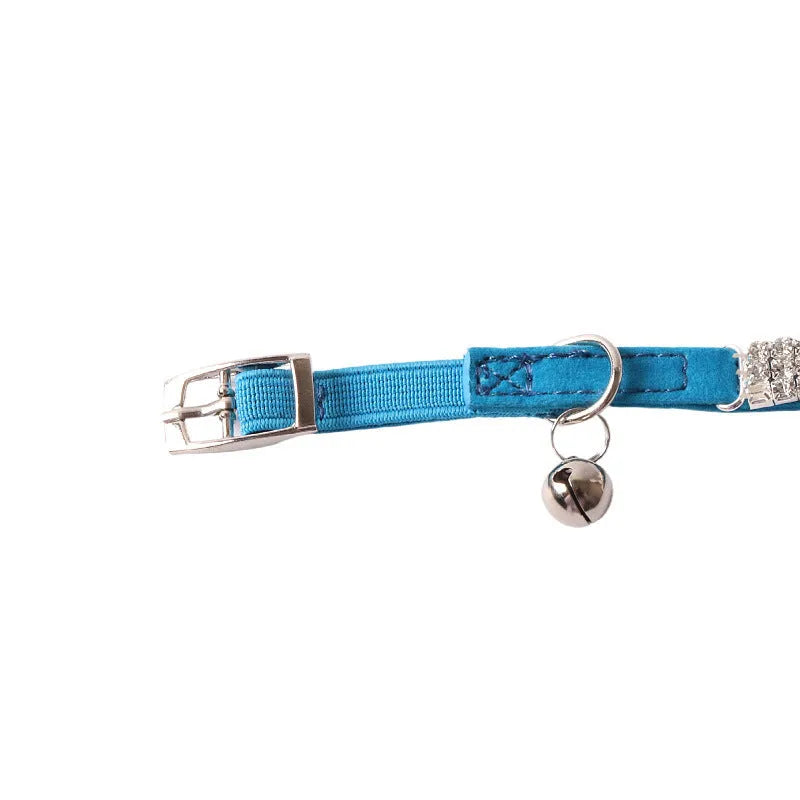 Soft flocked cat collar with elastic buckle in multiple colours on a white background.
