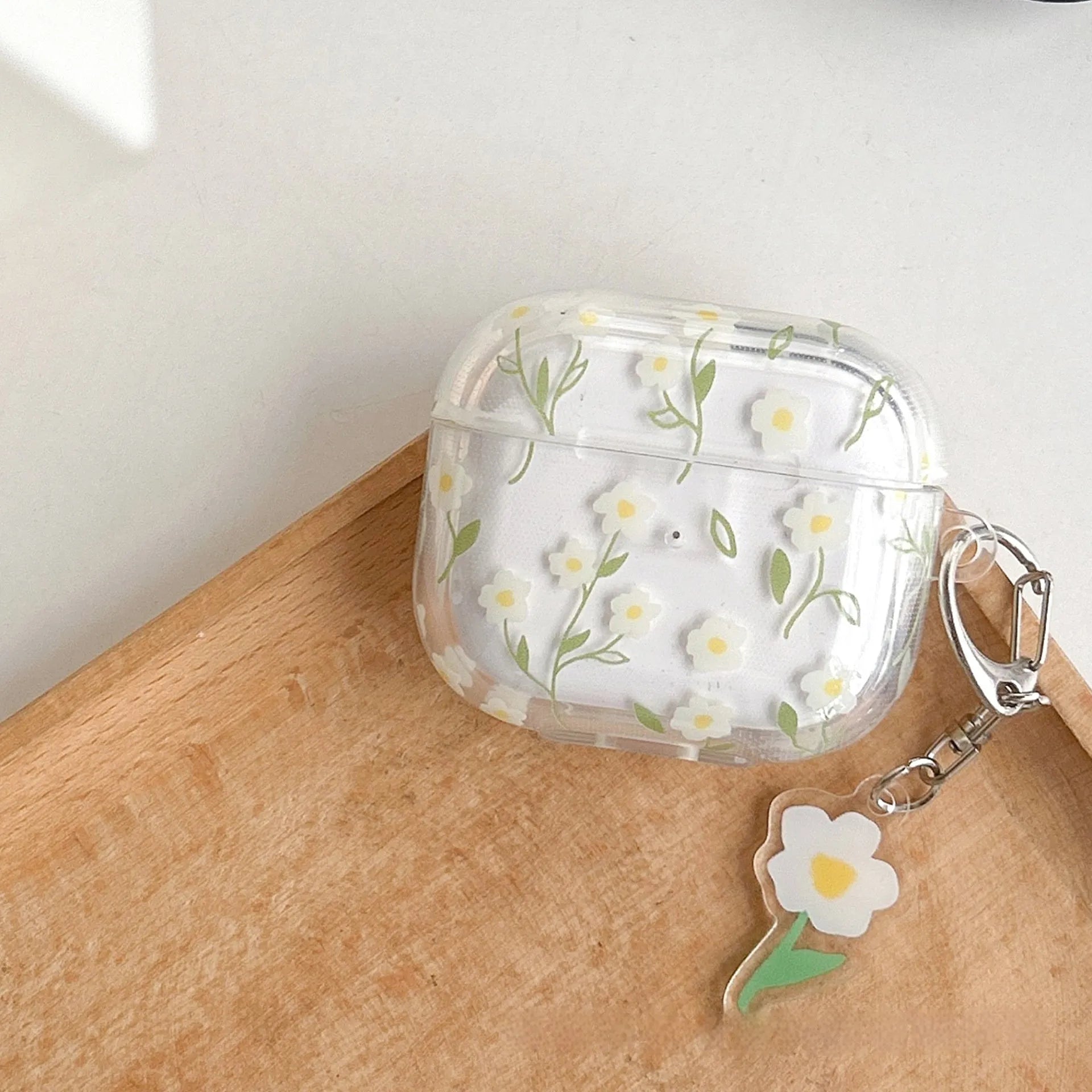 Clear TPU AirPods protective case cover with white floral design on transparent background