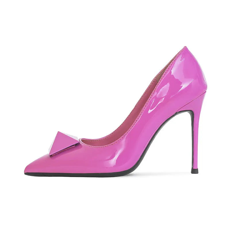 Pink patent leather women's stiletto heels with pointed toe, buckle strap, and rivet detail on a shallow cut.