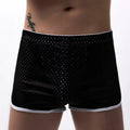 Men's cotton blend boxer shorts in black, shown laid flat to display mid-waist design and knitted fabric texture.