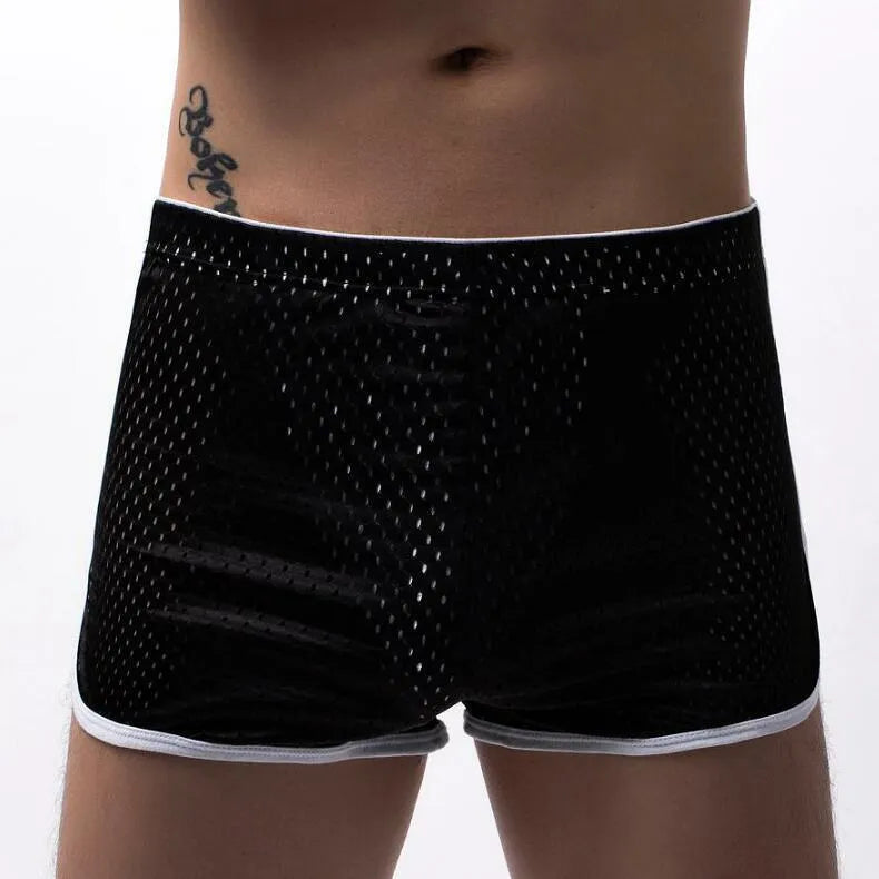 Men's cotton blend boxer shorts in black, shown laid flat to display mid-waist design and knitted fabric texture.