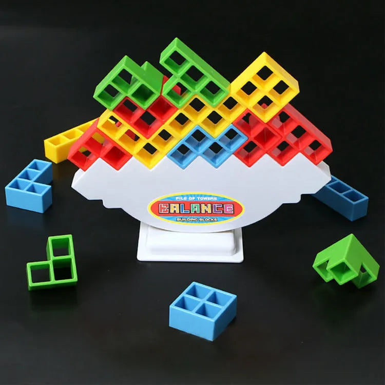 Plastic balance stacking board game with 16 coloured blocks, chassis, and base on a 26.5cm square box.