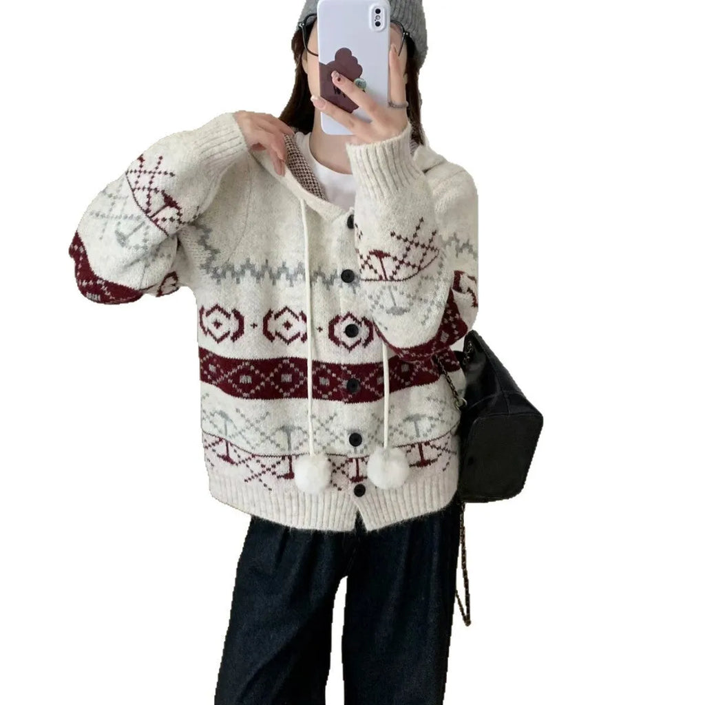 Plus size woman wearing a loose milky white geometric brocade sweater coat with long sleeves.