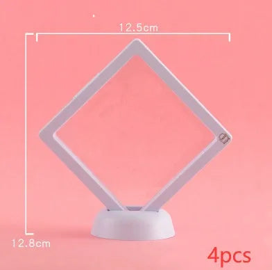 3D floating display case holding a coin suspended between transparent membrane sheets, black frame