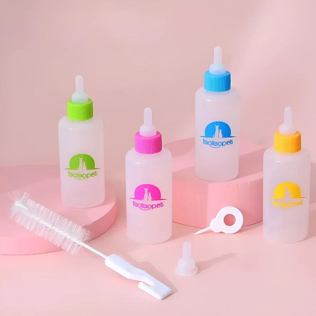 Four pet milk bottles in yellow, pink, blue, and green with a cleaning brush on a white background